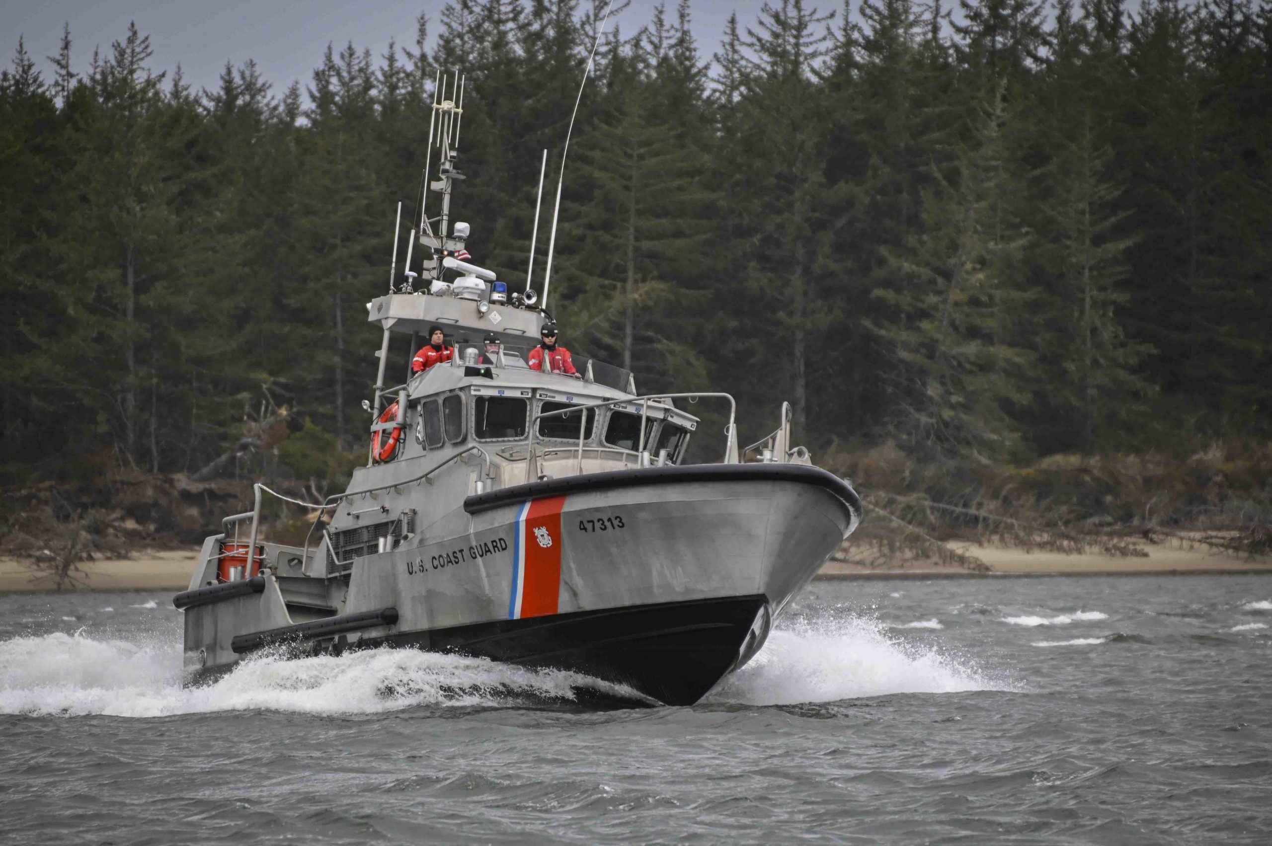 A crew aboard a 47-foot Motor Lifeboat from Coast Guard Station Umpqua River transits near Winchester Bay, Oregon, March 15, 2022. In addition to performing rough water rescues, the station's duties include enforcement of laws and treaties, marine environmental protection, maritime law enforcement, boating safety and implementation of commercial fishing vessel safety regulations. (U.S. Coast Guard photo by Petty Officer Steve Strohmaier)